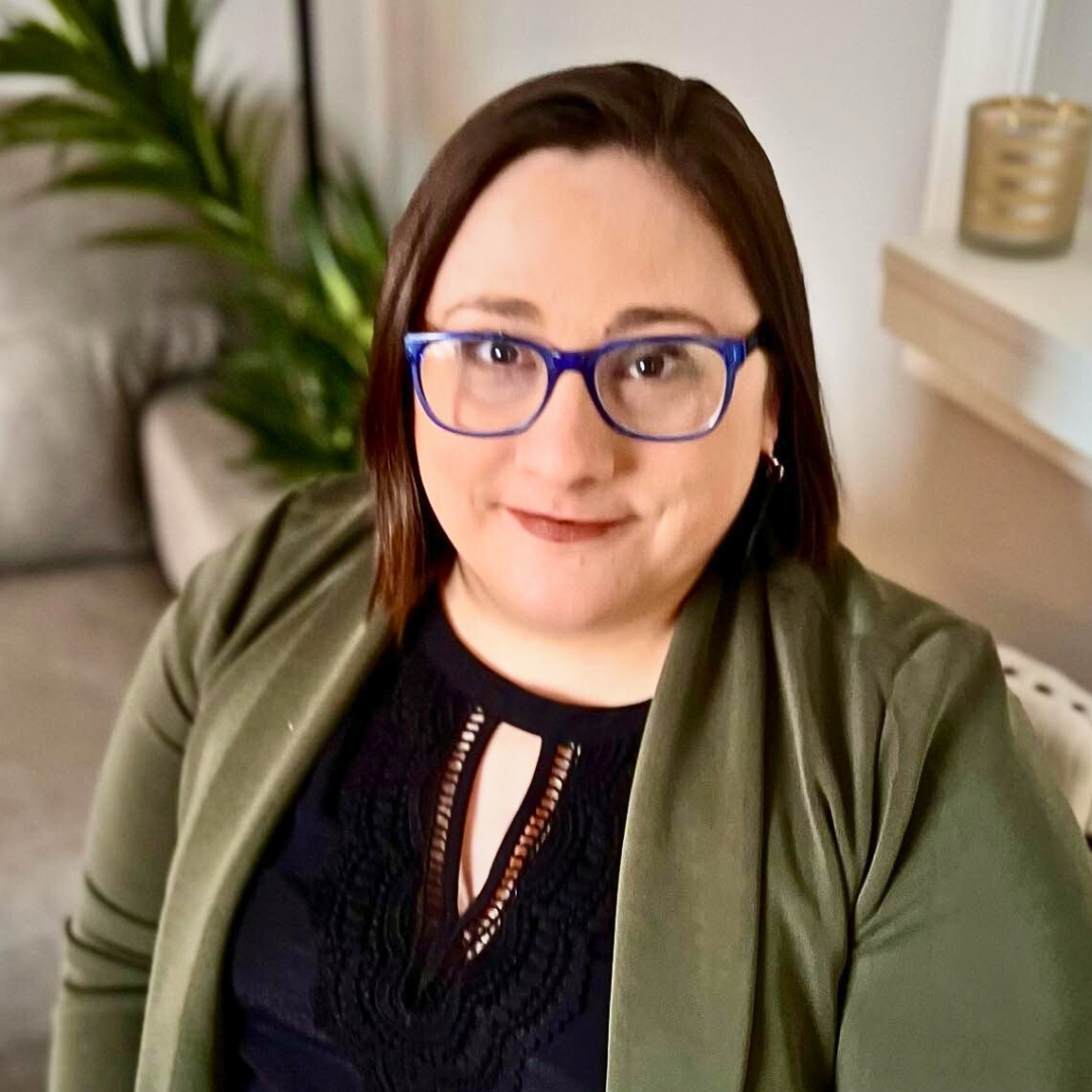 Woman with blue glasses in office setting