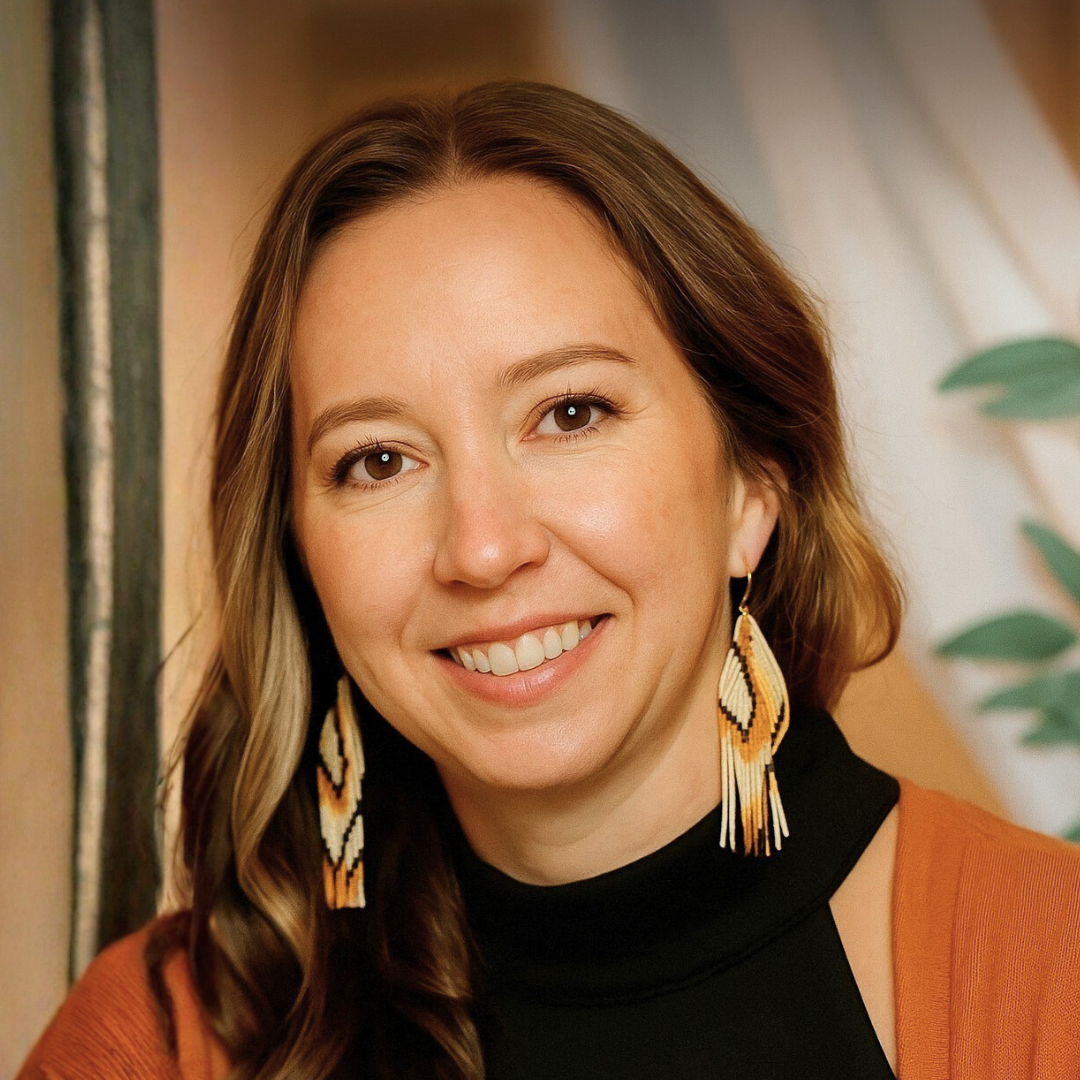 Smiling woman wearing patterned beaded earrings