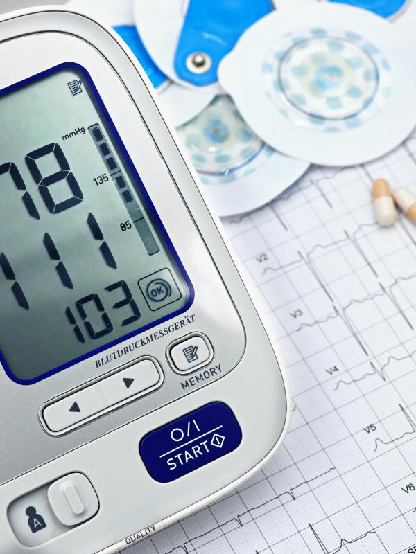 Digital blood pressure monitor showing elevated readings