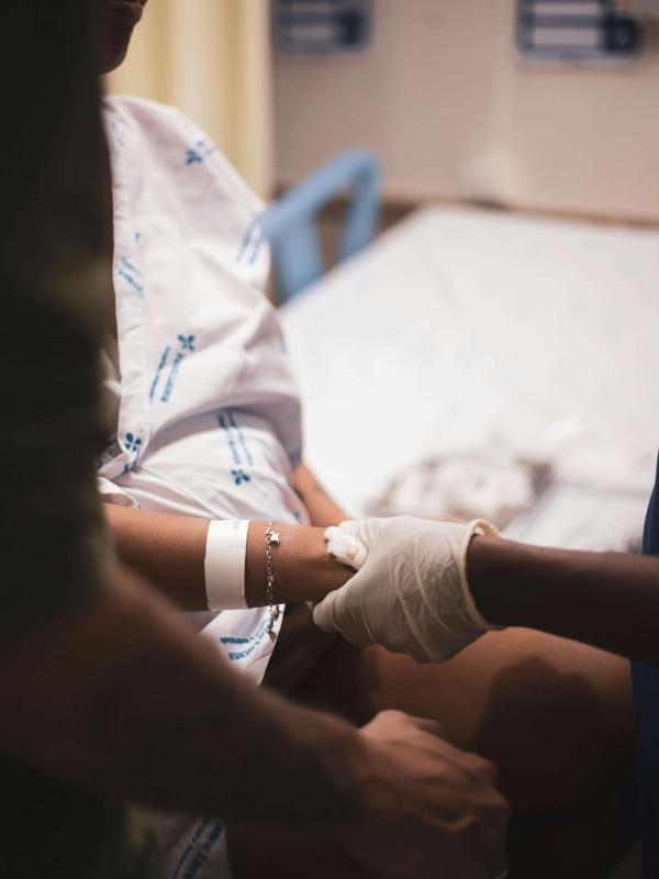 Healthcare professional supports patient’s wrist in hospital