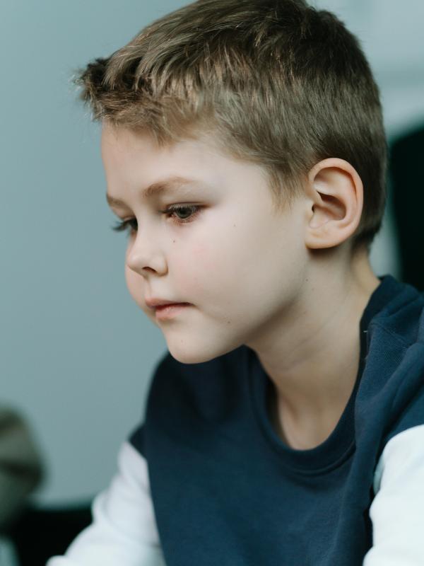 Close-up of a thoughtful child looking downward