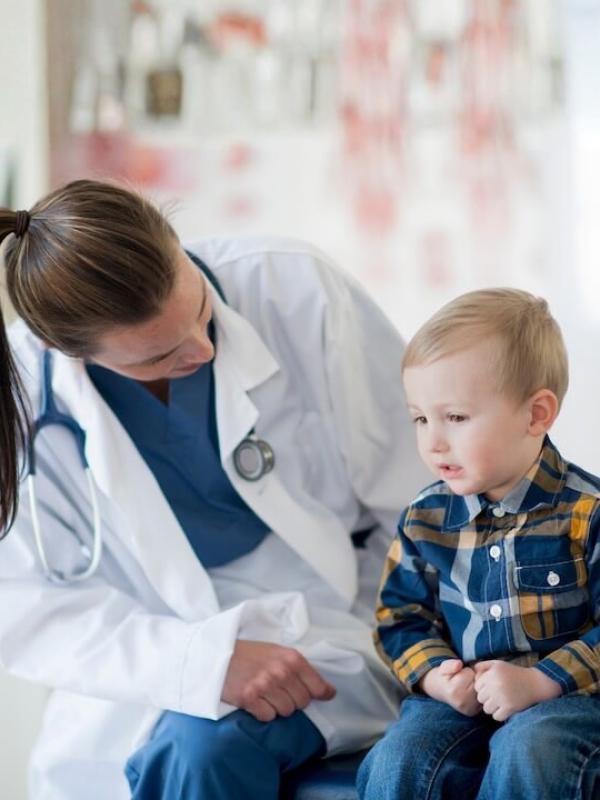 Healthcare professional talking to young child