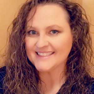 Portrait of woman with curly hair smiling