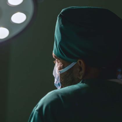 Surgeon in operating room under surgical lights