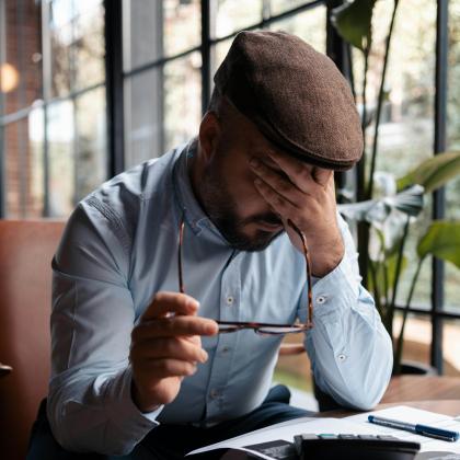 Person appearing stressed while reviewing documents
